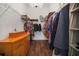 Well-lit walk-in closet featuring wire shelving, hanging storage, and hardwood floors at 7629 Lake Angelina Dr, Mount Dora, FL 32757