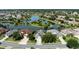 Scenic aerial view of homes surrounding a peaceful lake in a well-manicured community at 7873 Crosswinds Way, Mount Dora, FL 32757