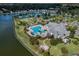Community aerial shot with lake, pool, fire pit and various sports venues with beautiful trees at 7873 Crosswinds Way, Mount Dora, FL 32757