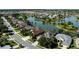 Aerial shot of a residential neighborhood featuring a waterfront community with well-maintained lawns and mature trees at 7873 Crosswinds Way, Mount Dora, FL 32757