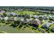 Wide aerial view showcasing a picturesque residential community with lakefront properties and lush green spaces at 7873 Crosswinds Way, Mount Dora, FL 32757