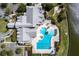 Aerial view of the clubhouse featuring a beautiful pool, parking lot, and grilling area at 7873 Crosswinds Way, Mount Dora, FL 32757