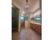 Bright bathroom with a glass shower and double vanity sinks for ease of use at 7873 Crosswinds Way, Mount Dora, FL 32757