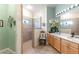 Bright bathroom with a glass walk-in shower and double vanity sink at 7873 Crosswinds Way, Mount Dora, FL 32757