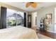 Bright bedroom featuring a large window with outdoor views and a walk-in closet entrance at 7873 Crosswinds Way, Mount Dora, FL 32757