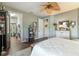 Light-filled bedroom with a ceiling fan that offers access to a laundry room and closet at 7873 Crosswinds Way, Mount Dora, FL 32757