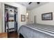 Cozy bedroom showcasing a comfortable bed, organized closet, and neutral decor at 7873 Crosswinds Way, Mount Dora, FL 32757