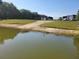 Community boat ramp leading into a pond surrounded by green lawns at 7873 Crosswinds Way, Mount Dora, FL 32757