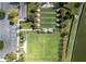 Overhead shot of bocce ball and playing courts with covered seating areas and landscaping at 7873 Crosswinds Way, Mount Dora, FL 32757
