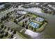 Aerial view of the community featuring lush landscaping, various amenities, and scenic waterfront views at 7873 Crosswinds Way, Mount Dora, FL 32757