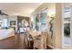 Bright dining area showcases a modern light fixture, adjacent to the open-concept living space at 7873 Crosswinds Way, Mount Dora, FL 32757