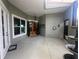 Inviting entryway with double doors, decorative plants, and view of the front yard through large window at 7873 Crosswinds Way, Mount Dora, FL 32757