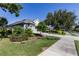 Charming single-Gathering home boasts lush landscaping and inviting curb appeal on quiet street at 7873 Crosswinds Way, Mount Dora, FL 32757