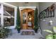 Charming front entrance with double doors, potted plants, and a welcoming atmosphere at 7873 Crosswinds Way, Mount Dora, FL 32757