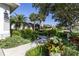 Charming home featuring a well-manicured lawn, lush landscaping, and a welcoming walkway at 7873 Crosswinds Way, Mount Dora, FL 32757