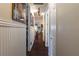 Hallway with wood floors and beadboard paneling looking into an open concept home at 7873 Crosswinds Way, Mount Dora, FL 32757