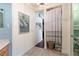 Hallway view including framed art piece, tiled floors, and access to closet and bathroom at 7873 Crosswinds Way, Mount Dora, FL 32757