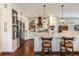 Open kitchen with a spacious island, pendant lighting, and white cabinetry at 7873 Crosswinds Way, Mount Dora, FL 32757