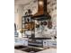Modern kitchen boasts a stylish backsplash, stainless steel appliances, and a custom wood range hood at 7873 Crosswinds Way, Mount Dora, FL 32757
