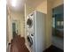 Conveniently located laundry room with stacked washer and dryer and ample storage shelving at 7873 Crosswinds Way, Mount Dora, FL 32757
