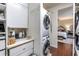 Bright laundry room with stacked washer/dryer, and convenient storage at 7873 Crosswinds Way, Mount Dora, FL 32757