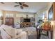Cozy living room with comfortable seating, large windows, and a view of the outdoor space at 7873 Crosswinds Way, Mount Dora, FL 32757
