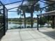 Outdoor patio with screened in area showcasing beautiful lake views at 7873 Crosswinds Way, Mount Dora, FL 32757