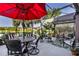Spacious screened patio showcases dining and seating areas and a tranquil waterfront view at 7873 Crosswinds Way, Mount Dora, FL 32757