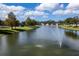 Picturesque view of the pond with a water fountain spraying water in the center of the pond at 7873 Crosswinds Way, Mount Dora, FL 32757
