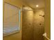 Tiled walk-in shower with diamond-shaped accents and a window provides natural light at 825 Mary Frank Ct, Mount Dora, FL 32757