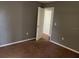 View of bedroom showcasing a plush carpet, neutral paint color, a closet and a doorway at 825 Mary Frank Ct, Mount Dora, FL 32757