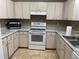 Functional kitchen with white appliances, ample cabinet space, and practical countertops at 825 Mary Frank Ct, Mount Dora, FL 32757