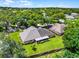 Stunning aerial view of a home on a large lot featuring lush landscaping and mature trees in a tranquil neighborhood at 8527 Firestone Cir, Clermont, FL 34711