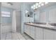 Bright bathroom features a double vanity, tub, and stand-alone shower at 8527 Firestone Cir, Clermont, FL 34711