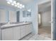 Bathroom featuring a double vanity and doorway access to the Primary bedroom at 8527 Firestone Cir, Clermont, FL 34711