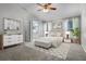 Stylized bedroom with neutral color palette, bright natural light and decorative wall art at 8527 Firestone Cir, Clermont, FL 34711