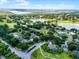Panoramic aerial view showcasing a community with serene lakes, lush golf course, mature trees, and picturesque homes at 8527 Firestone Cir, Clermont, FL 34711
