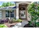 Charming home featuring an arched entryway, manicured landscaping and lovely flowering bushes at 8527 Firestone Cir, Clermont, FL 34711