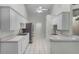 Well-lit kitchen with white cabinets, modern appliances, and tile flooring, offering a functional and stylish cooking space at 8527 Firestone Cir, Clermont, FL 34711
