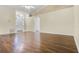 Open-concept living space with wood flooring, a ceiling fan, and ample natural light, perfect for entertaining guests at 8527 Firestone Cir, Clermont, FL 34711