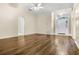 Bright and airy living room with vaulted ceiling, wood floors, and an arched entry, creating a welcoming atmosphere at 8527 Firestone Cir, Clermont, FL 34711
