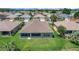 Backyard aerial view featuring a screen enclosed lanai and a lush green lawn at 8652 Se 133Rd Ln, Summerfield, FL 34491