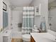 Cozy bathroom featuring a shower over the bath, neutral decor, and modern fixtures at 8652 Se 133Rd Ln, Summerfield, FL 34491