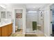 Bright bathroom with a glass shower and vanity sink at 8652 Se 133Rd Ln, Summerfield, FL 34491