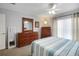 Bright bedroom featuring neutral walls, carpet floors, and light-filled window at 8652 Se 133Rd Ln, Summerfield, FL 34491
