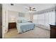 Bright bedroom with a ceiling fan, carpet floors, white curtains, and a light blue comforter at 8652 Se 133Rd Ln, Summerfield, FL 34491