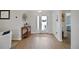 Welcoming foyer with wood floors, decorative console table, and view of the front door at 8652 Se 133Rd Ln, Summerfield, FL 34491