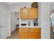 Functional kitchen nook with ample cabinet space and marble countertops, perfect for a coffee or snack station at 8652 Se 133Rd Ln, Summerfield, FL 34491