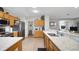 Open-concept kitchen with stainless steel appliances, marble countertops, and wood cabinets, offering a seamless flow at 8652 Se 133Rd Ln, Summerfield, FL 34491