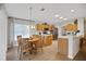 Open-plan kitchen with wooden units, light worktops, and dining table at 8652 Se 133Rd Ln, Summerfield, FL 34491